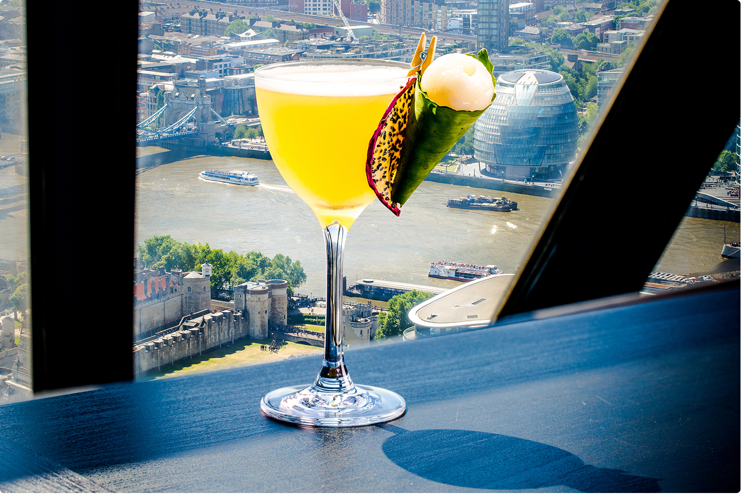 Cocktail on table overlooking London city scape